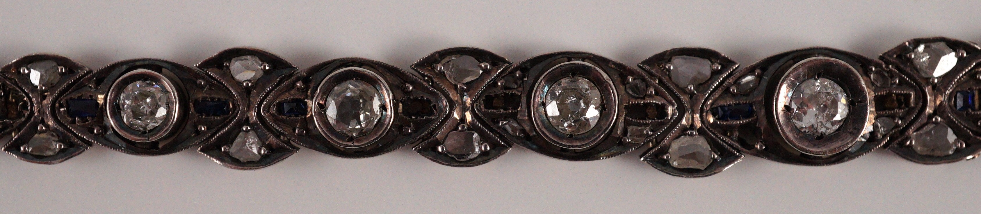 An early to mid 20th century continental gold and silver, graduated diamond and sapphire set line bracelet